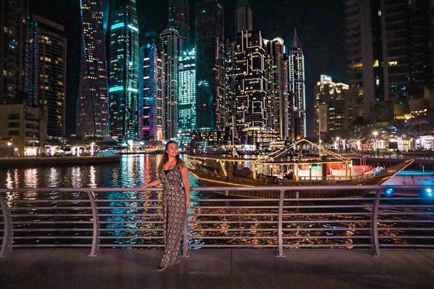 A person standing by a waterfront with a city skyline in the background. 4