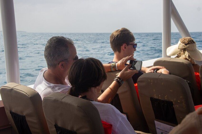 People on a boat with a view of the ocean. 5
