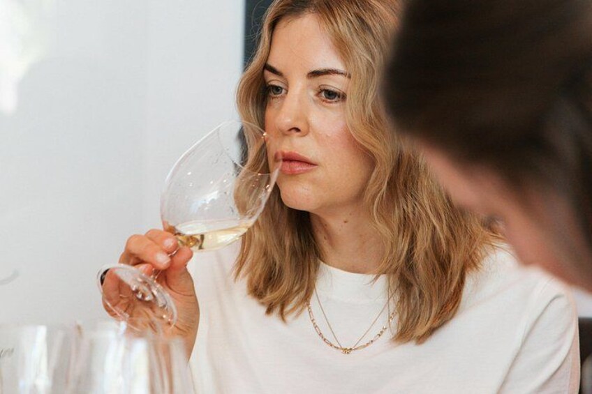 A person holding a wine glass. 5