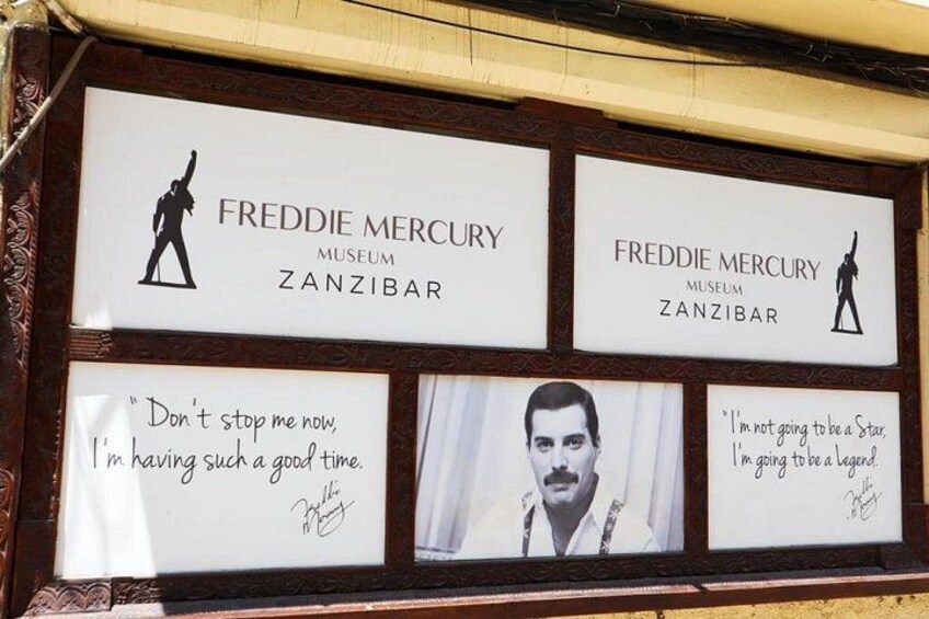 A framed display with text and images related to Freddie Mercury, including quotes and a silhouette. 2