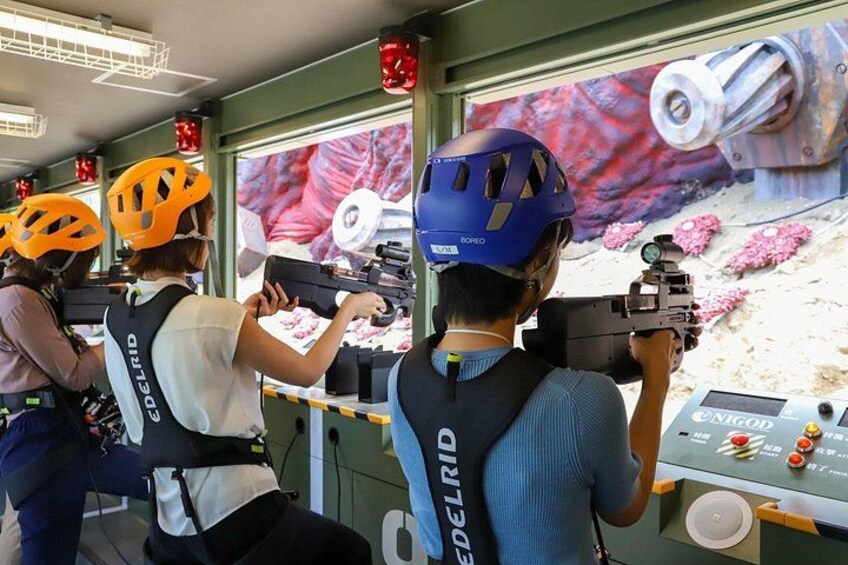 People aiming at targets with rifles, wearing helmets and safety gear. 5