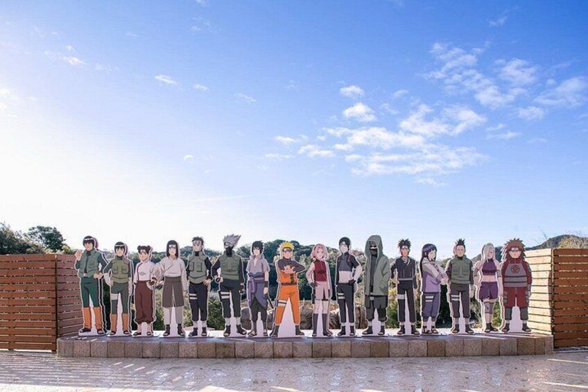A group of people standing on a platform outdoors with a clear sky. 2