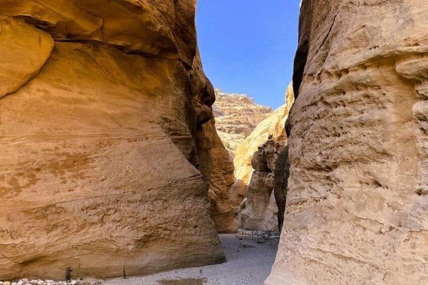 A canyon with steep rock walls and a clear sky. 4