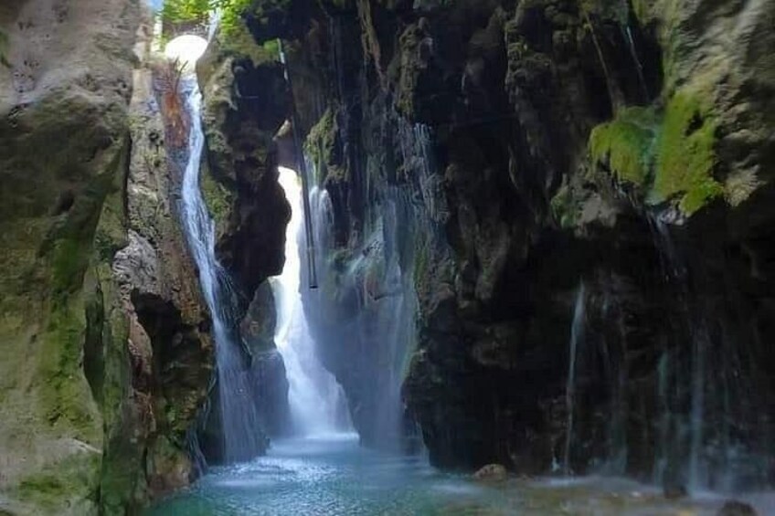 A cave with a waterfall. 1