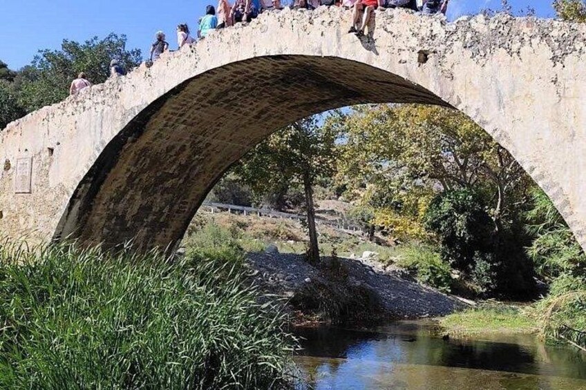 A stone bridge with people walking on it. 3