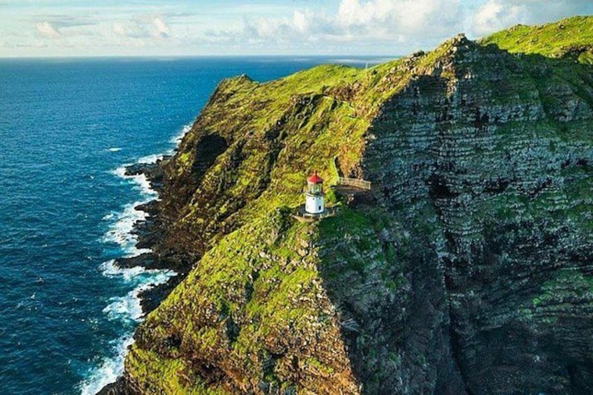 A lighthouse on a cliff overlooking the ocean. 4