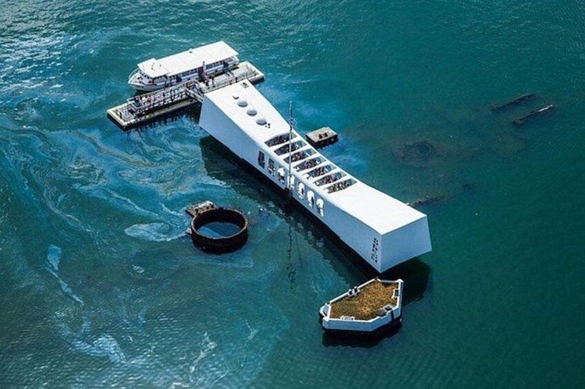 A floating structure with a dock, a large white building, and a circular object in the water. 2