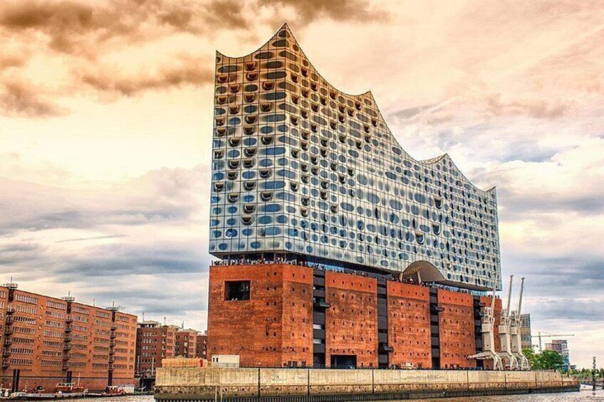 A modern building with a unique wavy top and a grid of windows. 2