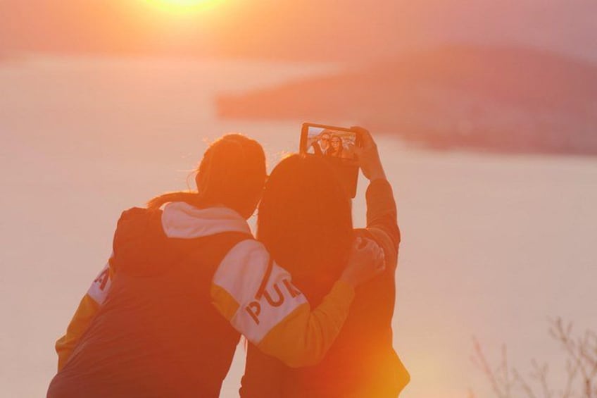 Two people taking a photo with a camera. 2