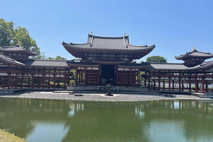 A traditional Japanese temple with a pond in front. 1