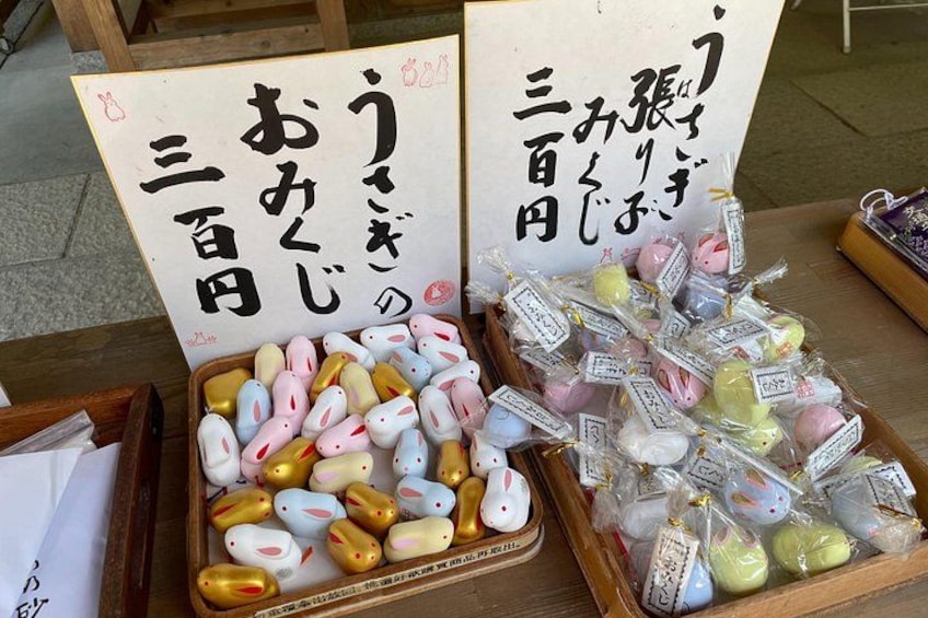 A display of colorful egg-shaped sweets with Japanese text. 4
