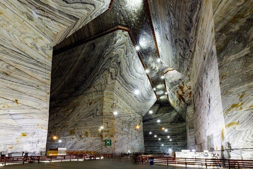 A large indoor space with high ceilings and walls made of marble. 1