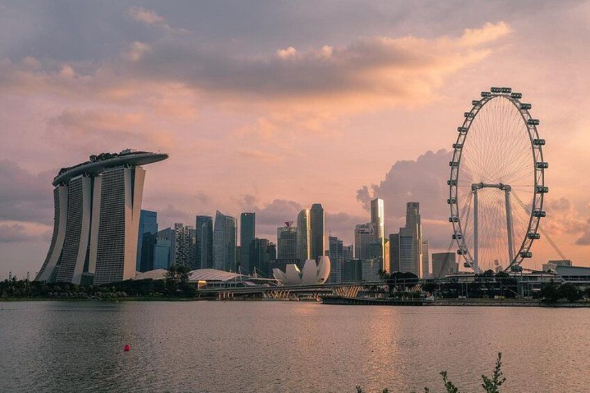 A city skyline with a prominent Ferris wheel and a distinctive building with a curved top. 1