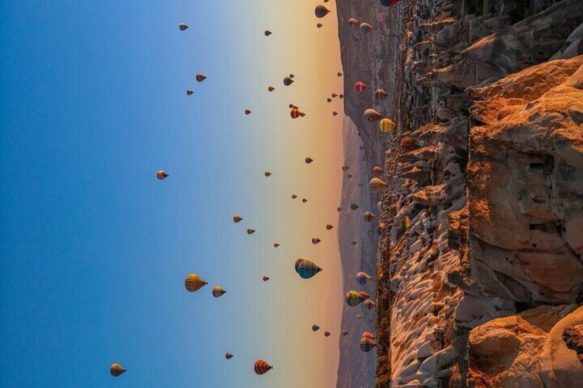 A clear sky with numerous hot air balloons. 5