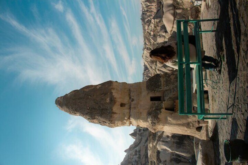 A rock formation with a green metal structure in the foreground. 2