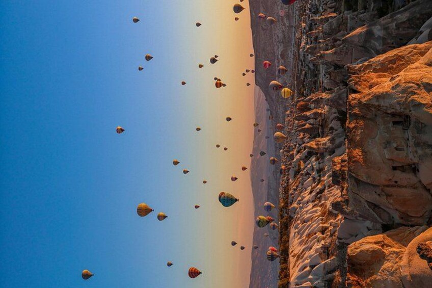 A clear sky with numerous hot air balloons. 5