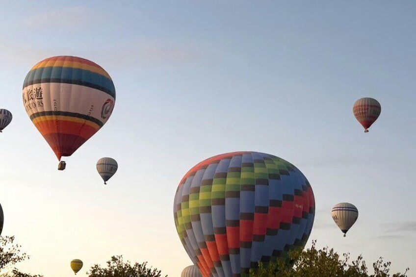 Multiple hot air balloons in the sky. 3