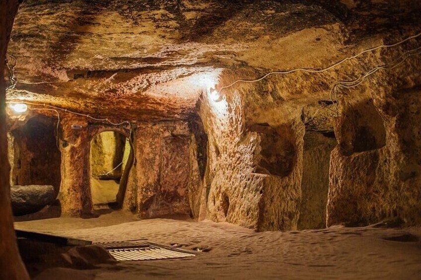 A cave with natural rock formations and a light source illuminating the area. 3