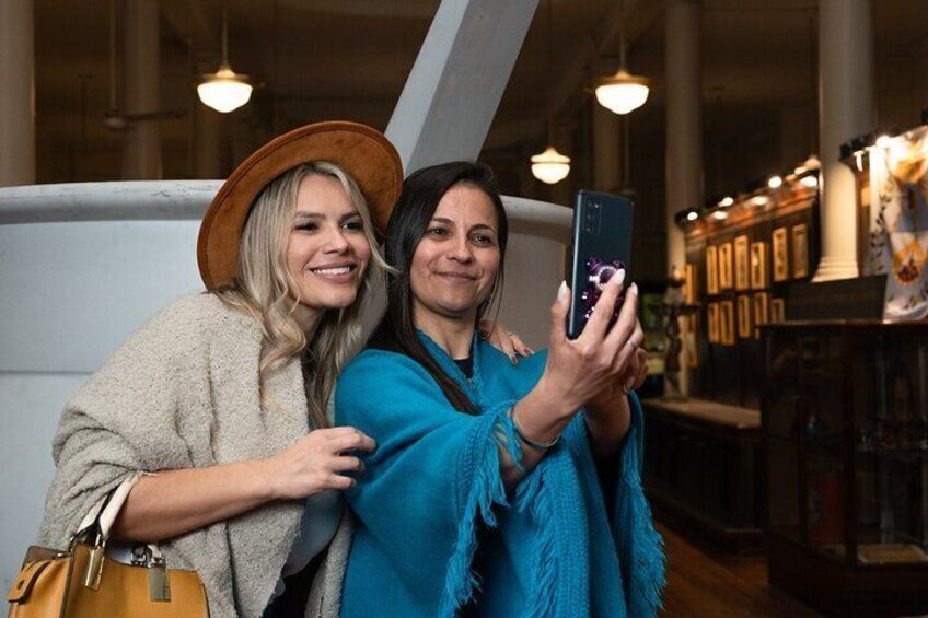 Two people taking a selfie in a bookstore. 3