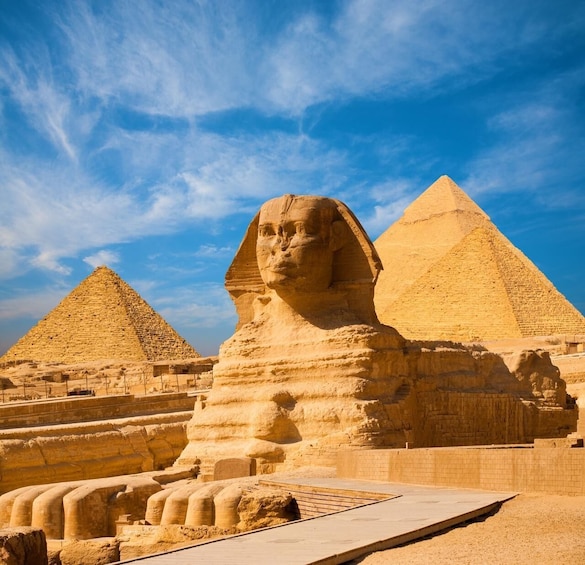 The Great Sphinx and two pyramids in the background. 5