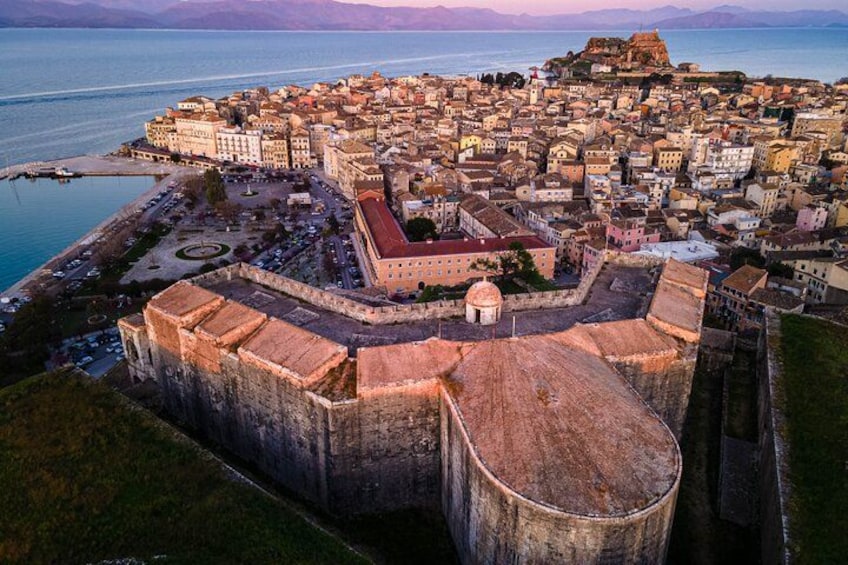 A coastal city with a prominent fortification, a historic building, and a body of water. 3