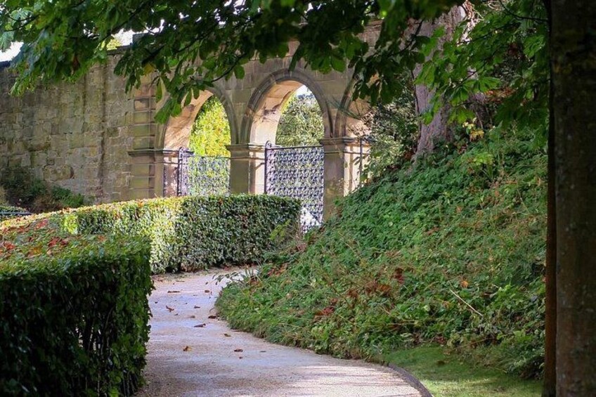 A stone bridge, a curved pathway, and lush greenery. 4