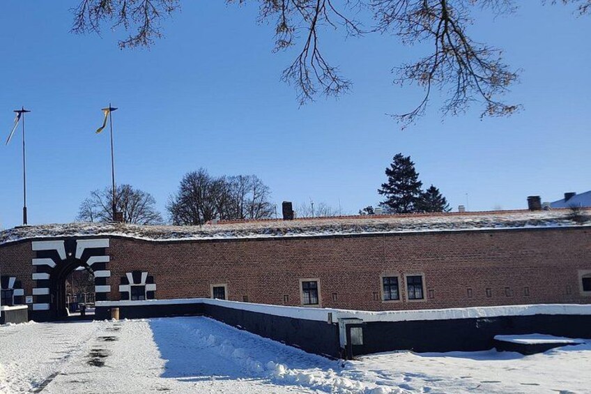 En murstensbygning med snebelagt tag og sneklædt grund. 1