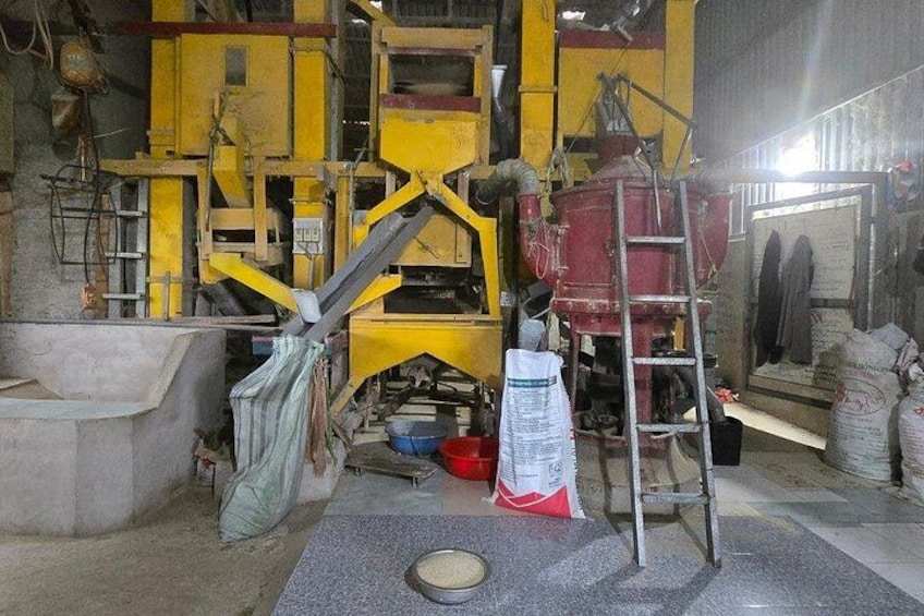 A large industrial machine with yellow and red components, a ladder, and a concrete floor. 4