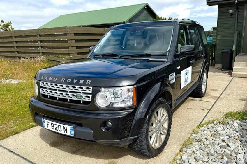 A black Land Rover SUV parked on a driveway. 3