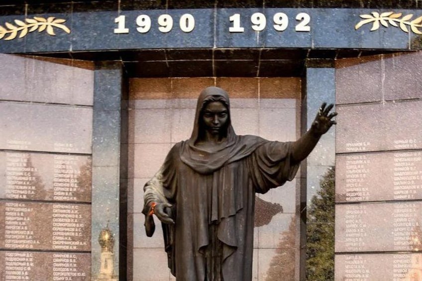 A statue with inscriptions and the years 1990 and 1992. 5