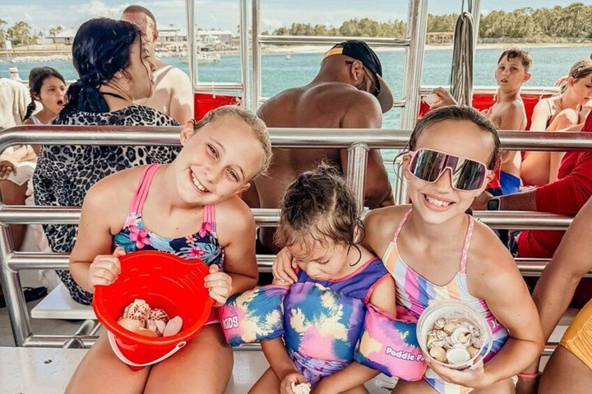 People on a boat, some holding food containers. 2