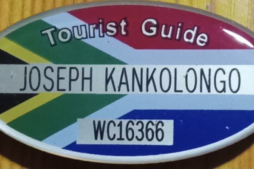 A tourist guide badge with the name 'JOSEPH KANKOLONGO' and a code 'WC16366'. 3