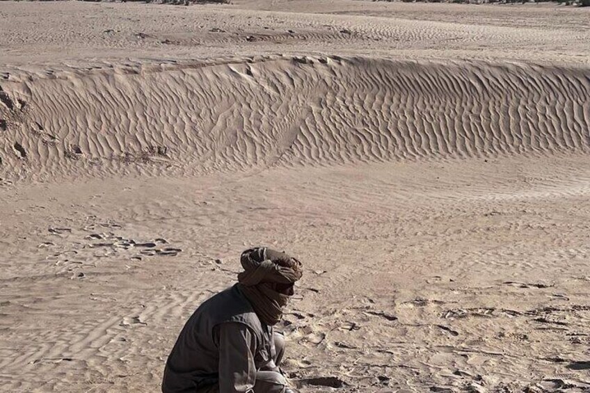 A person in a desert landscape with sand dunes. 5