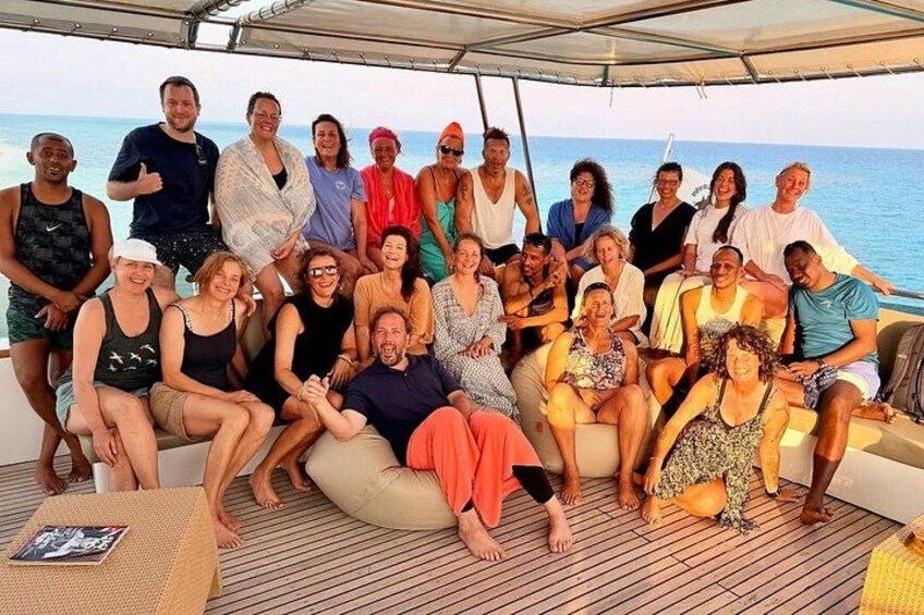 A group of people on a boat with a view of the ocean. 2