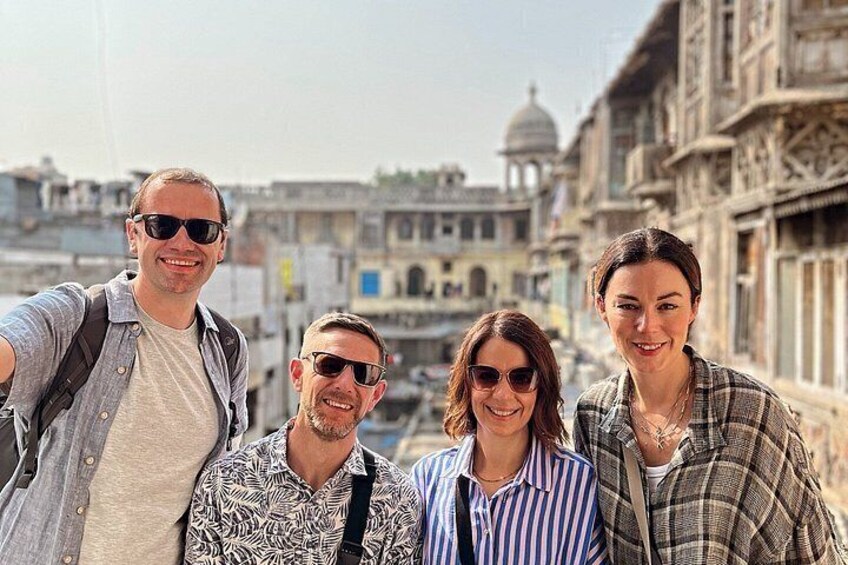 A group of people taking a selfie with a historic building in the background. 3