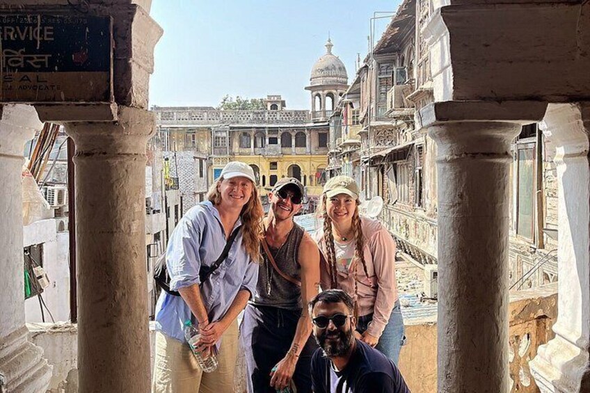 A group of people standing in front of an old building with columns and domes. 2