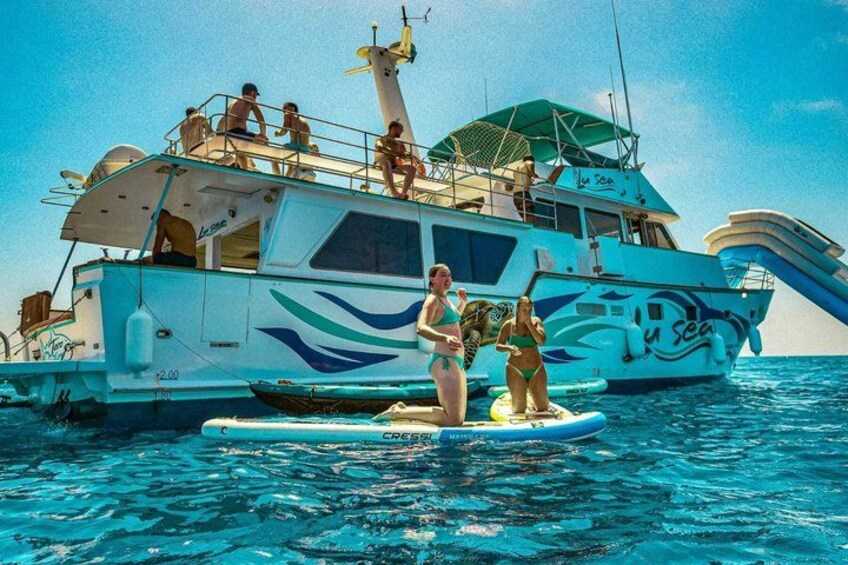 A boat with people on a floating platform in the water. 3