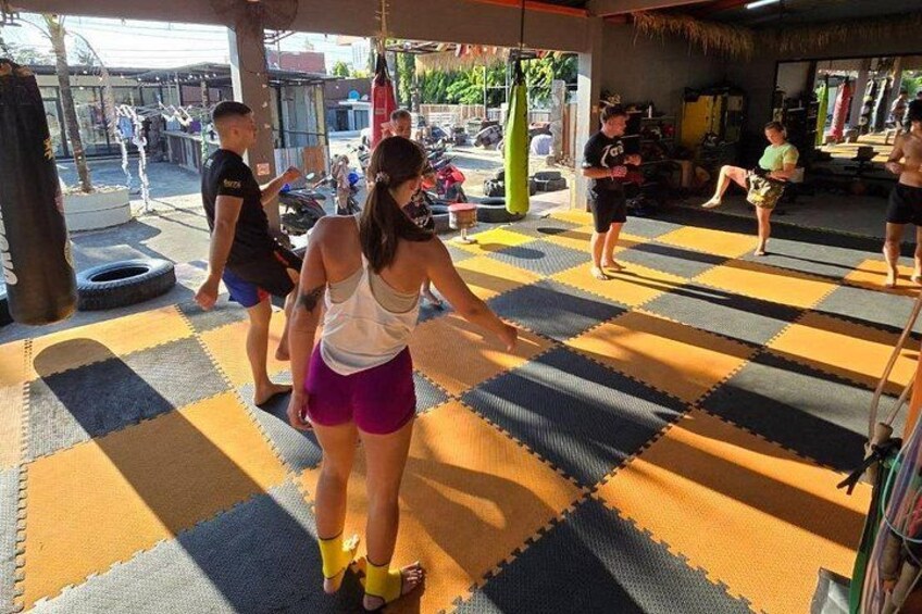A martial arts training area with mats, punching bags, and training equipment. 3