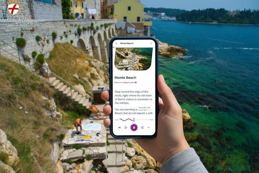 A hand holding a smartphone displaying a photo of Monte Beach with text describing the location. 1