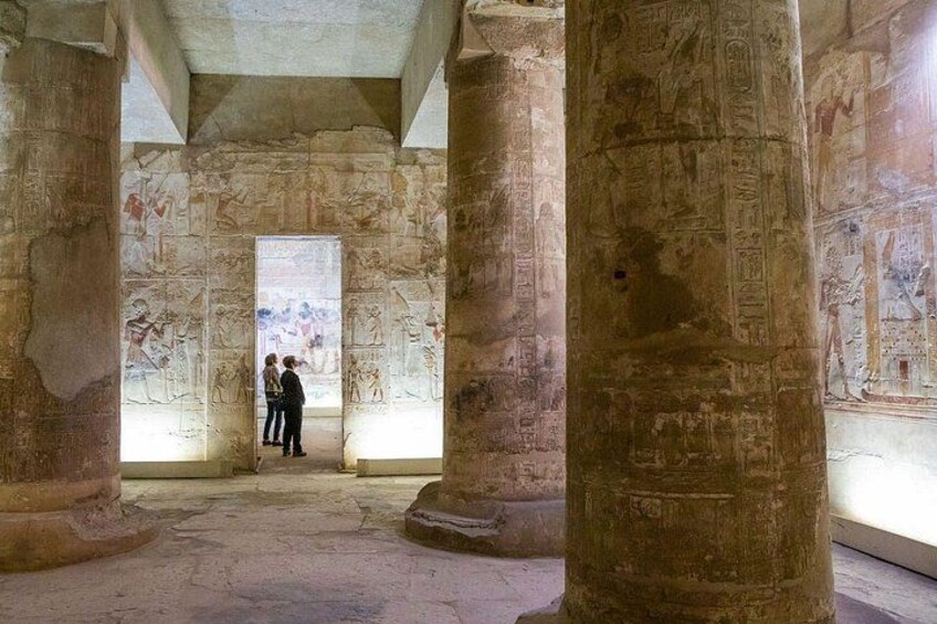 An ancient Egyptian temple interior with hieroglyphs and columns. 4