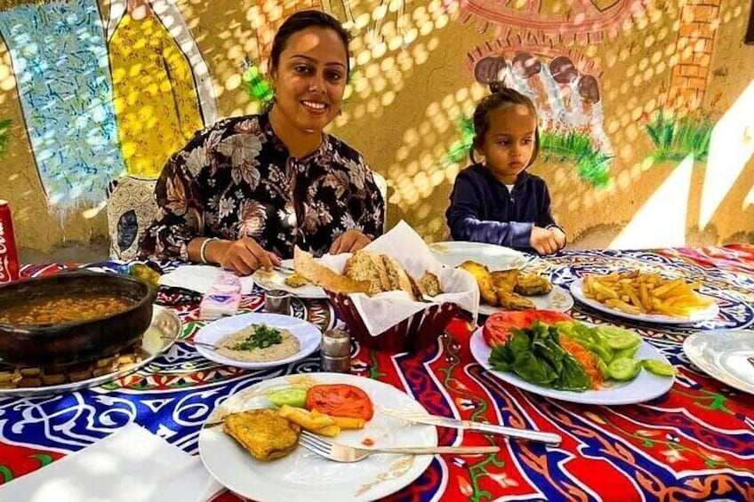 A person and a child dining at a table with various dishes. 1