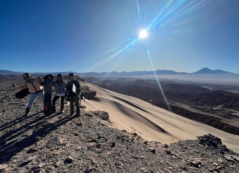 A group of people on a mountain with a clear sky and a bright sun. 3