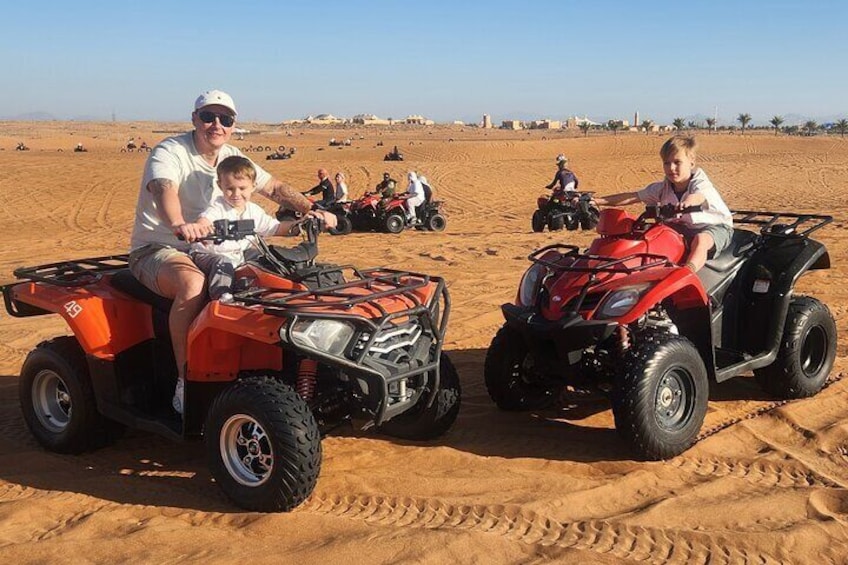 People riding ATVs in a desert. 5
