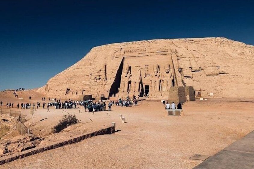 A large pyramid with hieroglyphics and a crowd of people in front. 3