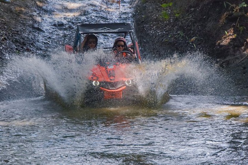 A vehicle driving through water, creating a splash. 3