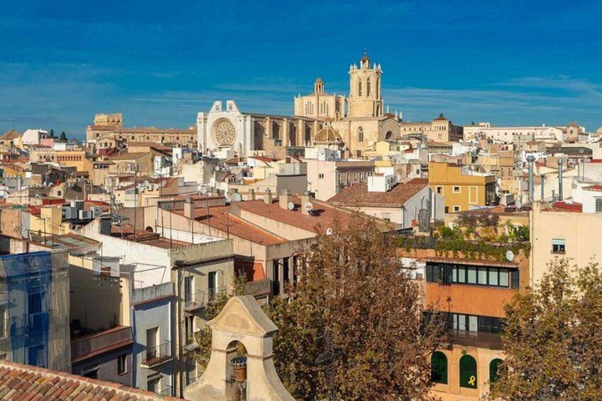 A cityscape with a prominent church and cathedral, surrounded by residential buildings. 5
