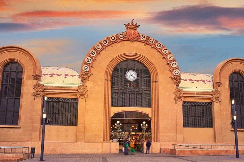 A historic train station with ornate arches and a clock. 3