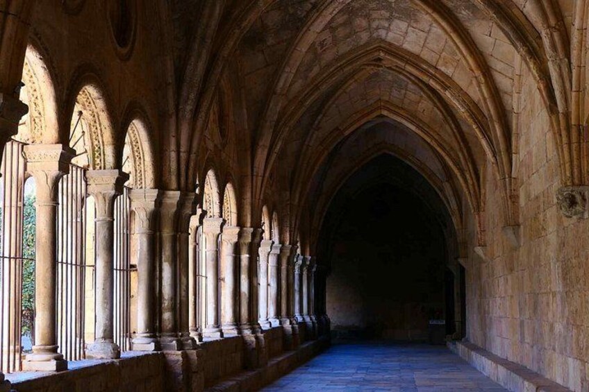 A cathedral nave with Gothic arches and columns. 4