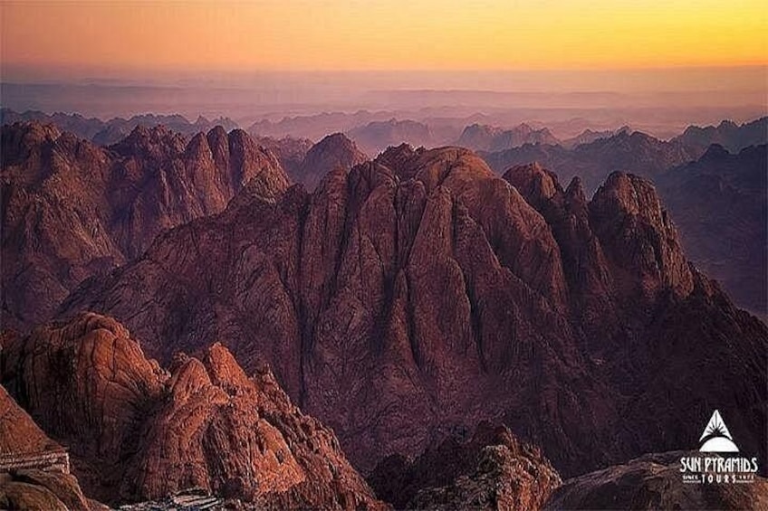 A mountain range at sunset with rugged peaks and a clear sky. 3