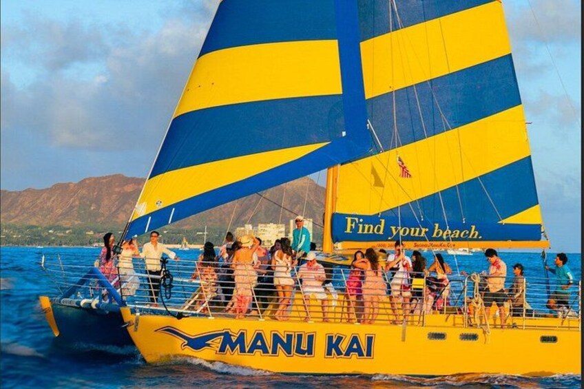 A yellow and blue sailboat with people on board, a mountainous landscape in the background, and the text 'Find your beach' on the sail. 1